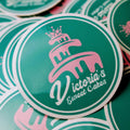 Stickers with 'Victoria's Sweet Cakes' logo on a green background